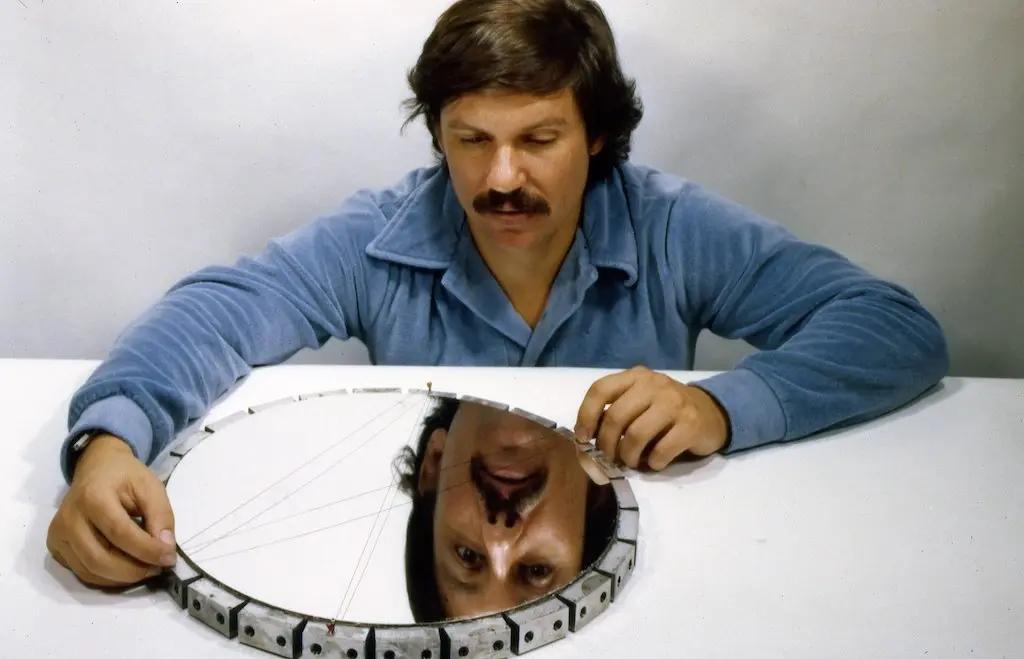 Jerry Nelson, the father of segmented mirroring peering into a mirror at the Lick Observatory